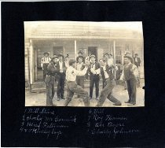 Sepia photo of several young men fighting